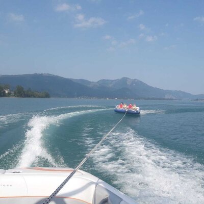 Recreational water tubing on the lake, highlighting activities available near the Farm House.