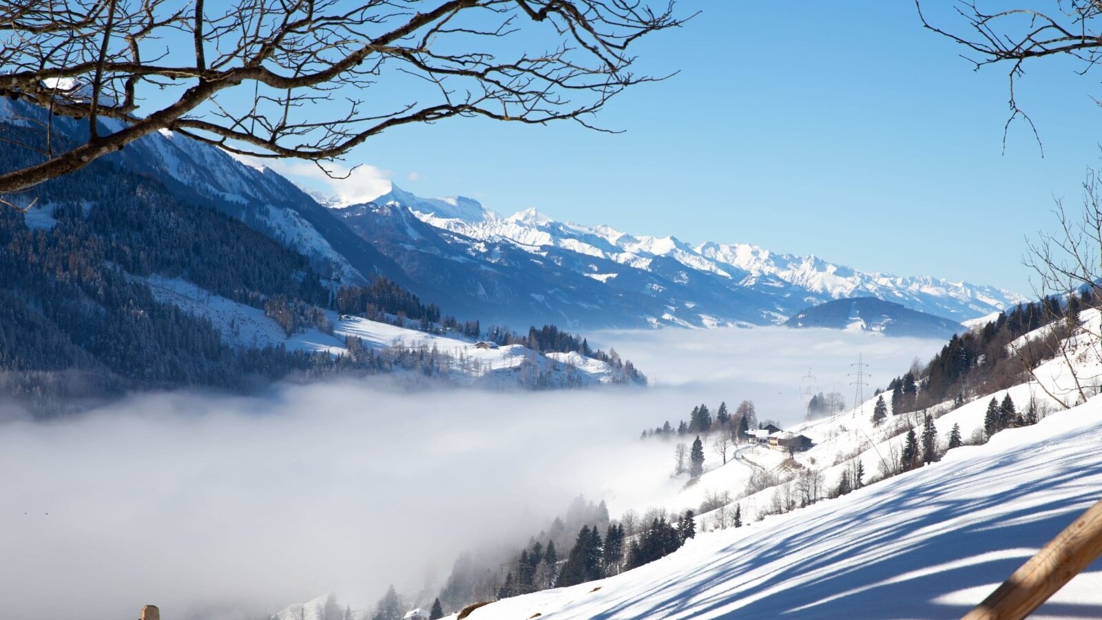 The Farm House offers views of snow-covered mountains and a valley covered in fog.