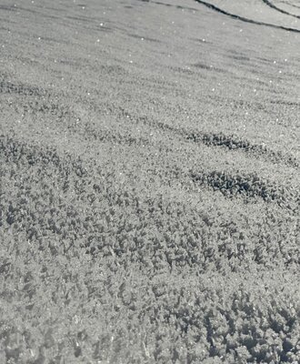 Close-up of snow with visible ice crystals, characteristic of the winter landscape at the holiday home.