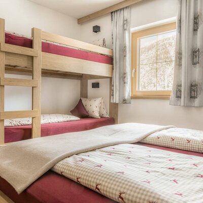 Bedroom with a bunk bed and a double bed.