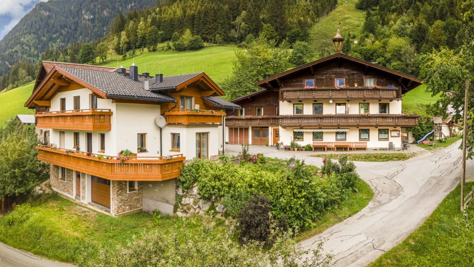 The inviting Bauernhof in a traditional style, surrounded by lush green meadows and dense forests.
