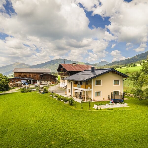 The inviting Bed and Breakfast surrounded by a spacious green lawn and scenic mountain views.