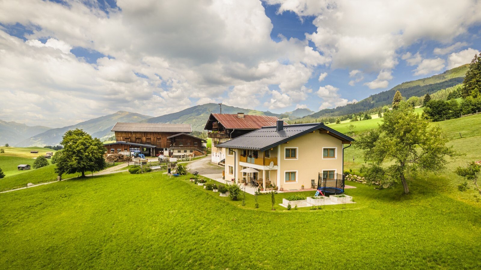 The inviting Bed and Breakfast surrounded by a spacious green lawn and scenic mountain views.