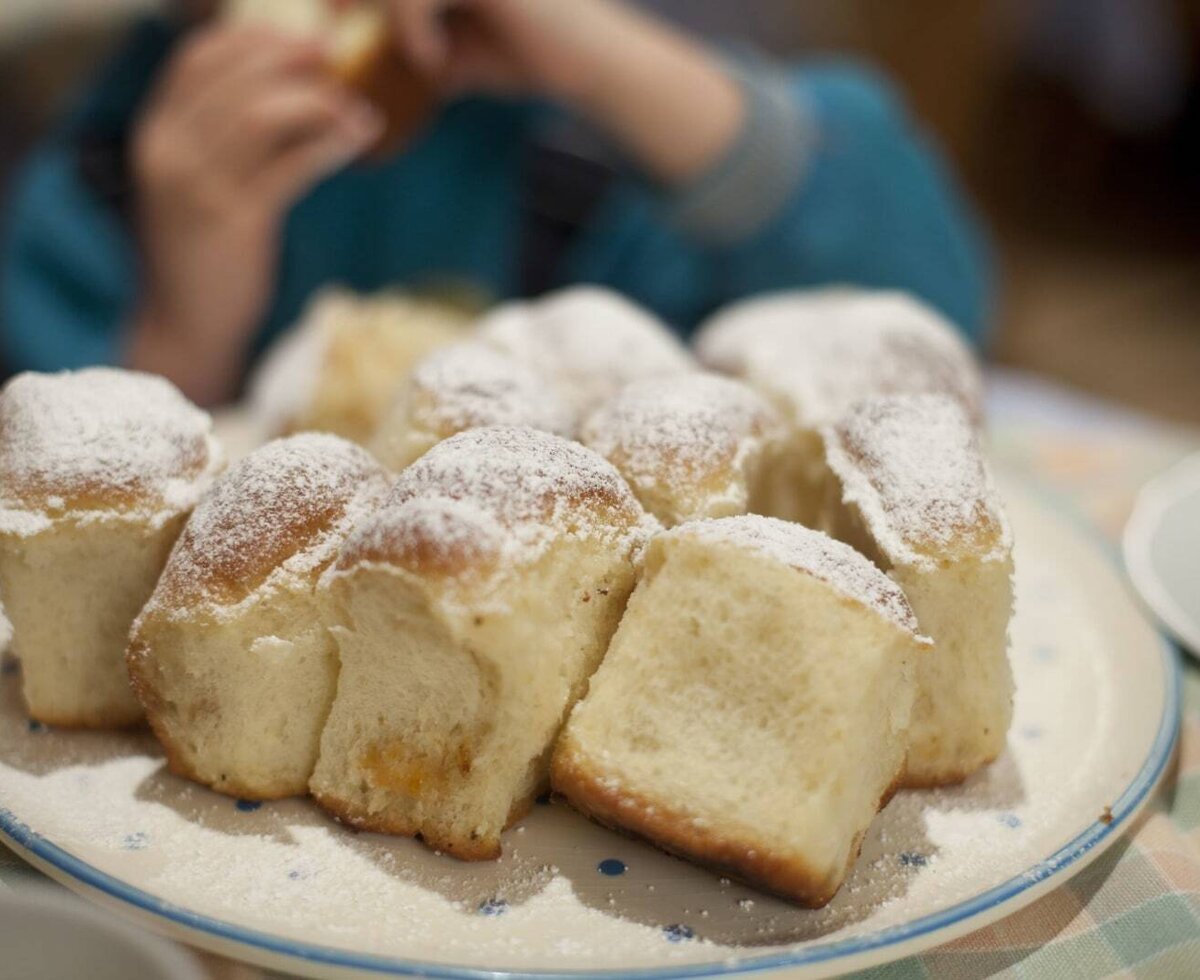 A plate of powdered sugar buns, a homemade treat for guests at the Farm House.