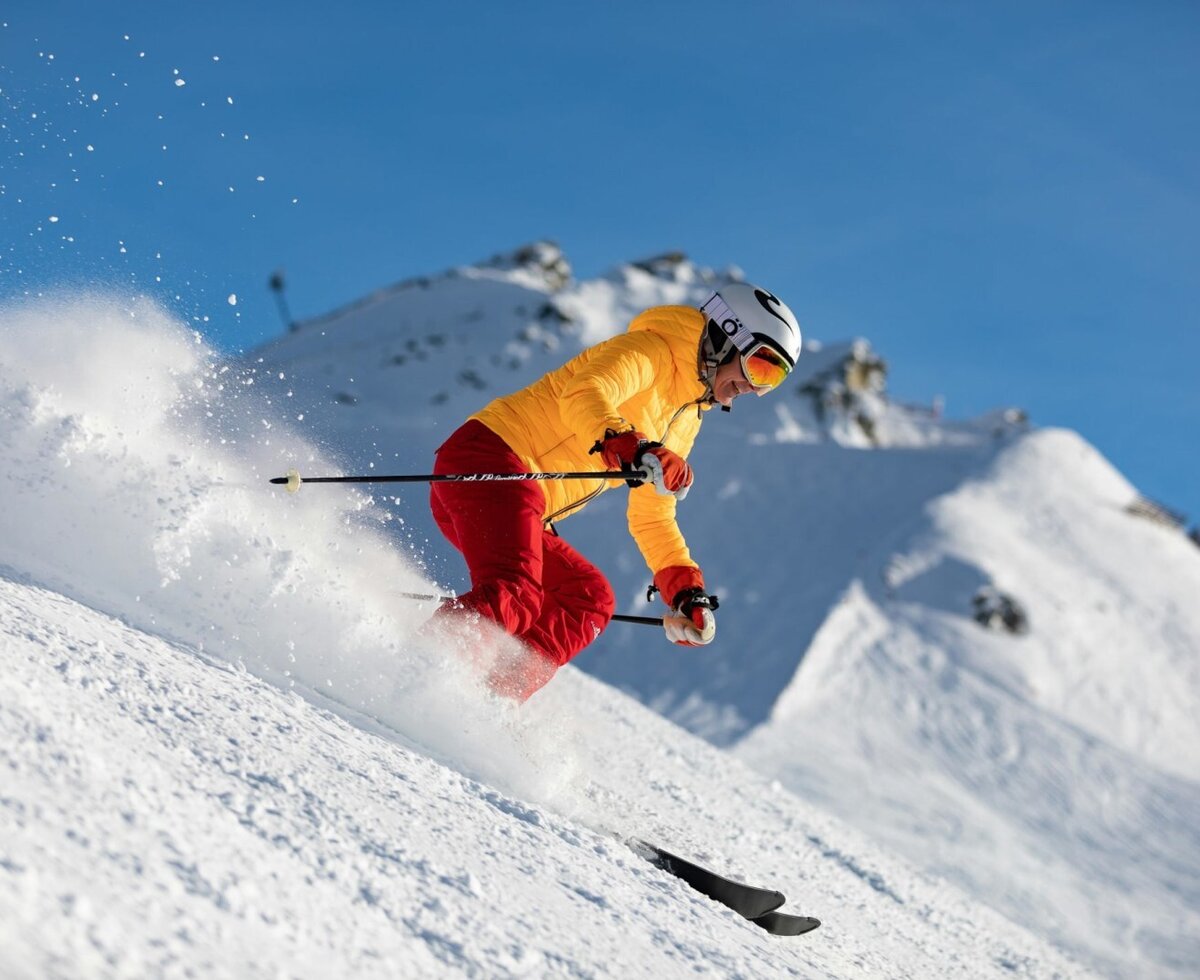 Skier on a snowy slope with mountains in the background, highlighting winter sports activities available near the Bed and Breakfast.