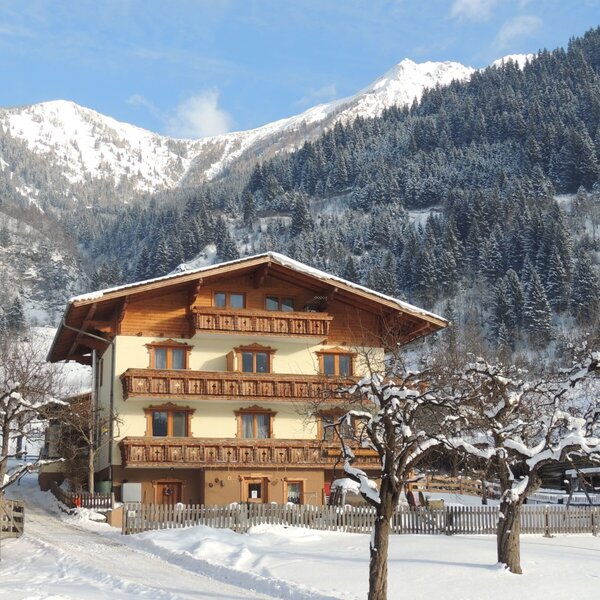 The exterior of the Farm House featuring traditional wooden balconies, surrounded by snow-covered grounds and mountains. The exterior of the Farm House featuring traditional wooden balconies, surrounded by snow-covered grounds and mountains.