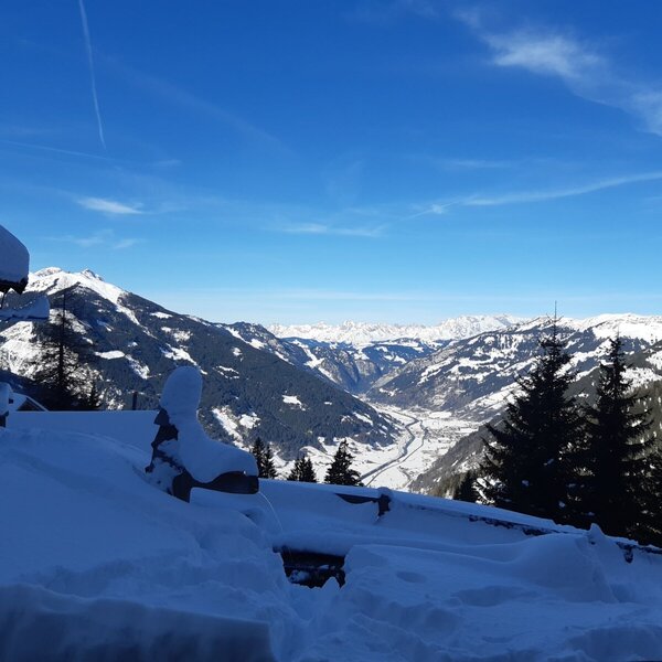 View from the farmhouse of a snow-covered valley and mountains under a clear blue sky. View from the farmhouse of a snow-covered valley and mountains under a clear blue sky.