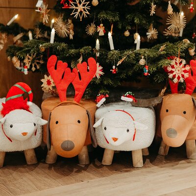 Christmas-themed animal footstools in front of the decorated Christmas tree at the farmhouse.