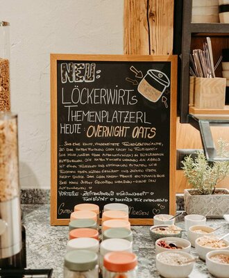 Breakfast offering at the farmhouse with overnight oats in jars and an information board.