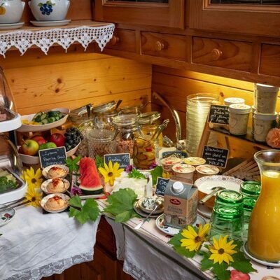 The breakfast buffet at the Bed and Breakfast with organic black bread, regional spreads, cold cuts, cheese, fresh fruit, yogurt, and juices.