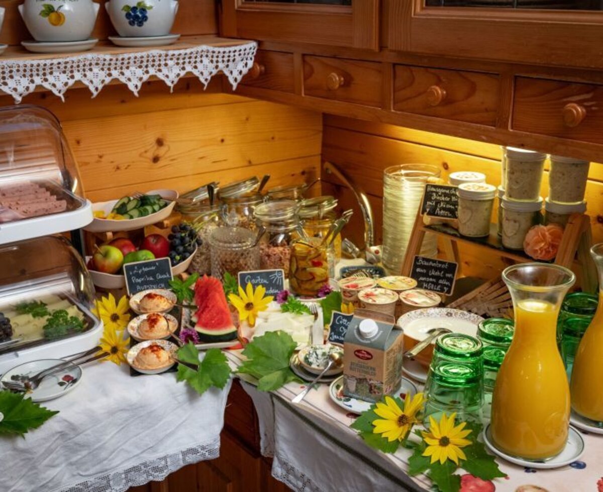 The breakfast buffet at the Bed and Breakfast with organic black bread, regional spreads, cold cuts, cheese, fresh fruit, yogurt, and juices.