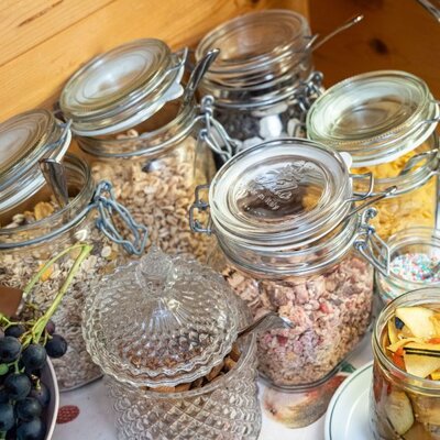 The Bed and Breakfast breakfast buffet featuring a selection of mueslis, cereals, and fresh fruit.