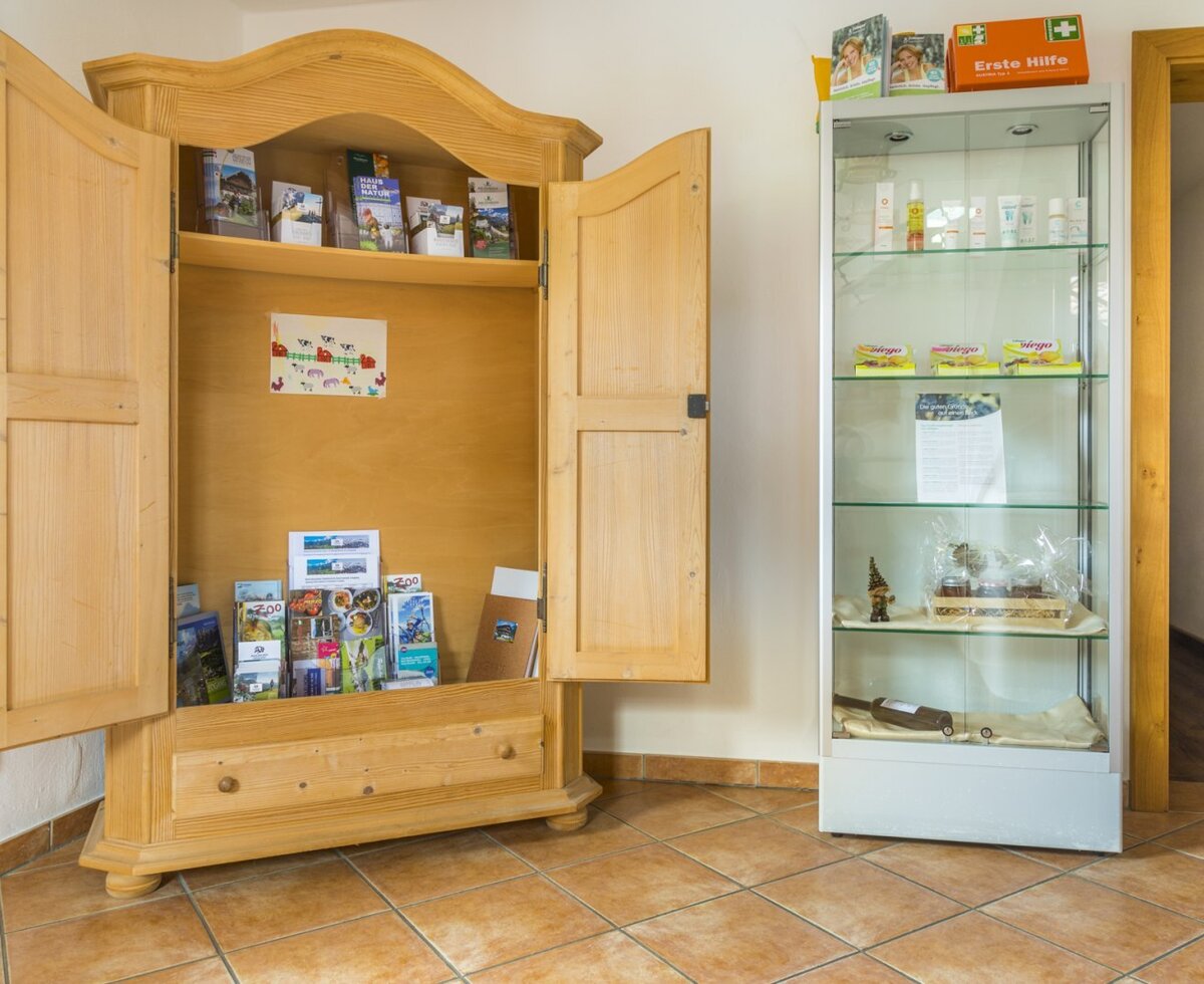 The farm house provides a wooden cabinet with local information brochures and a display case with first aid supplies and other amenities.