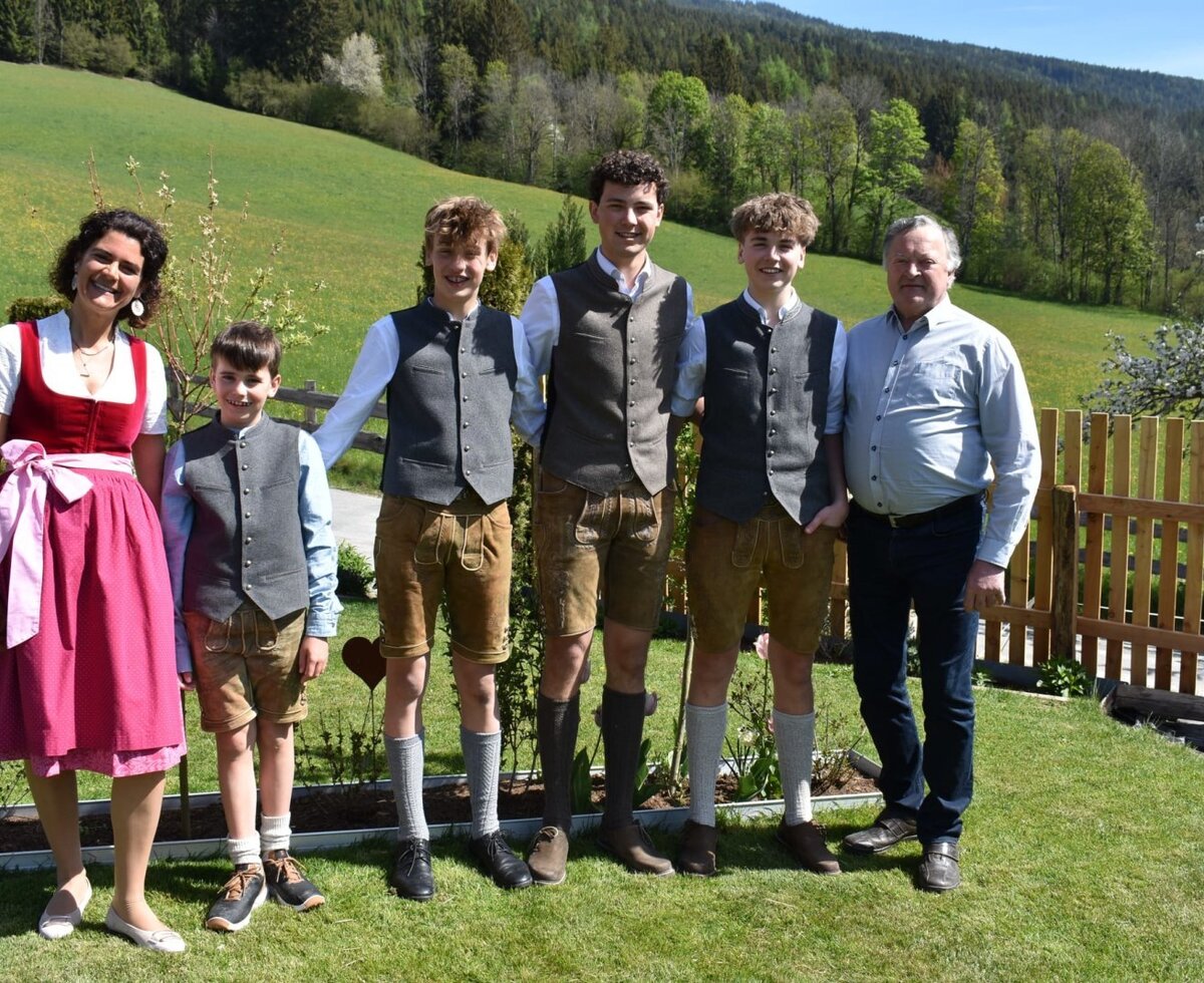 The host family of the farmhouse in traditional attire.