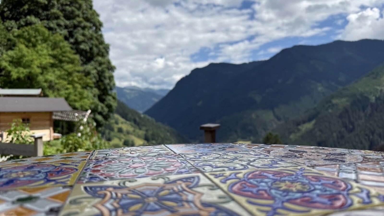 An inviting view from the farmhouse across a beautifully tiled table towards the surrounding mountains.