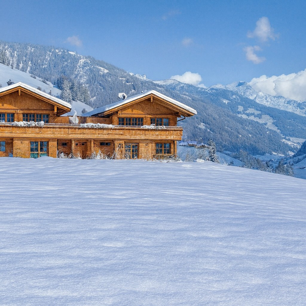 Our chalets building in a snowy mountain landscape.