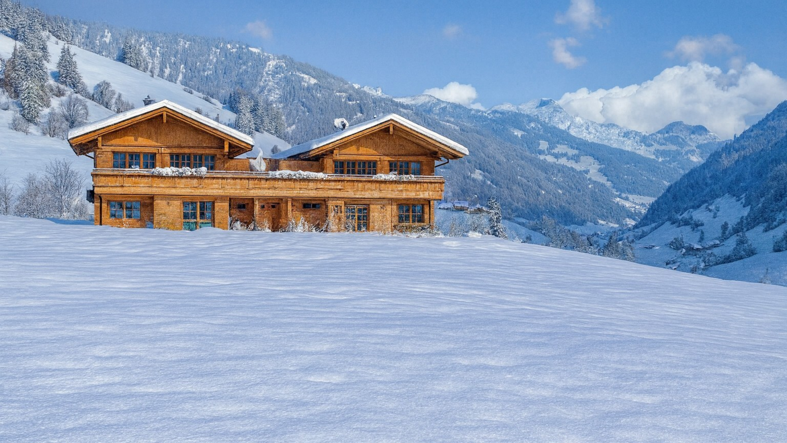 Our chalets building in a snowy mountain landscape.