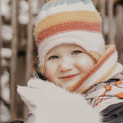 A child holds a white rabbit, one of the child-friendly activities available at the farmhouse.