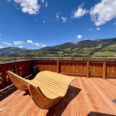 The farmhouse has a large sun terrace with comfortable wooden loungers and views of the mountains and the Salzach valley.