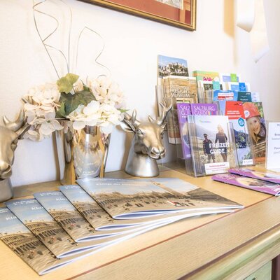 The farmhouse provides an information area with local tourist guides, activity brochures, and Wi-Fi login details for guests.