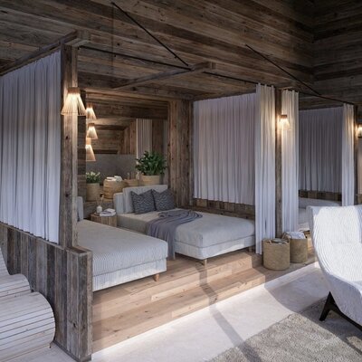 The farmhouse's relaxation area, featuring wood paneling, daybeds with privacy curtains, and comfortable armchairs.