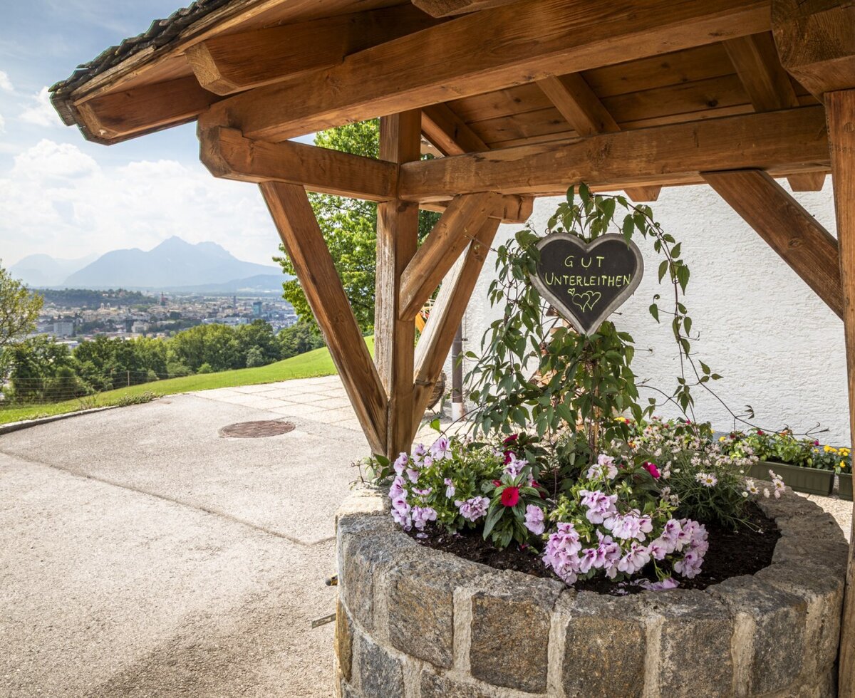 A beautifully decorated flower well at the farmhouse, offering scenic views of the surrounding landscape.