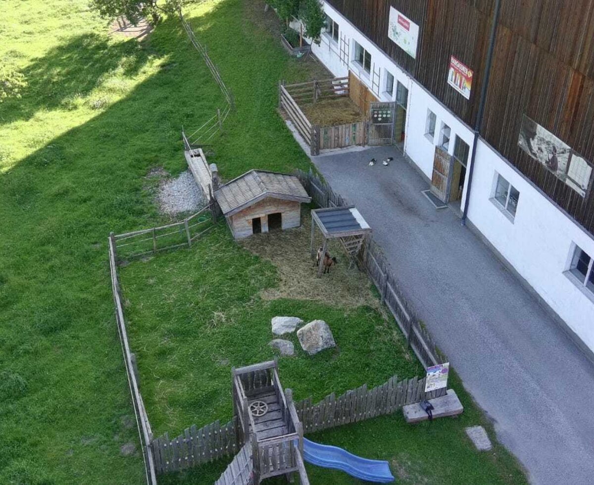 The Farm House features outdoor animal pens and a children's playground with a slide.