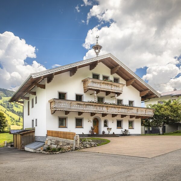 The inviting apartment set in a traditional Alpine house, surrounded by idyllic mountain scenery.