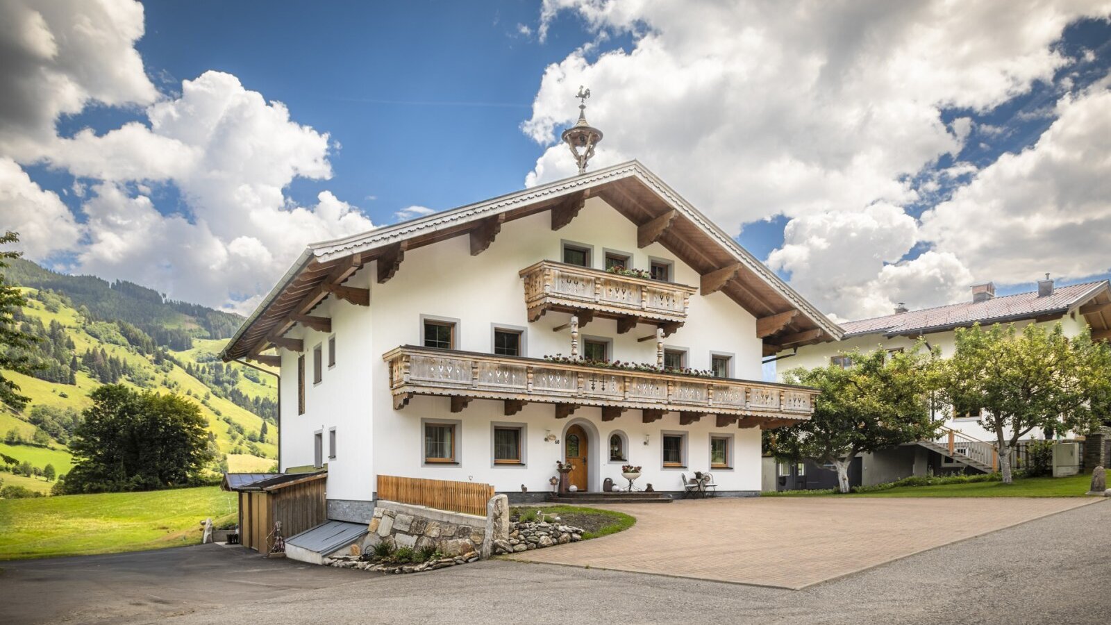 The inviting apartment set in a traditional Alpine house, surrounded by idyllic mountain scenery.