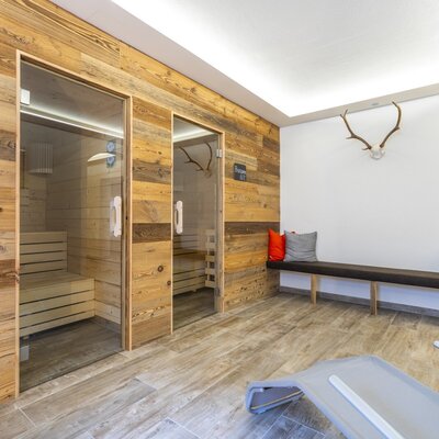 The farm house's wellness area includes a Finnish sauna, a steam sauna, a relaxation bench, and a lounge chair for guests.