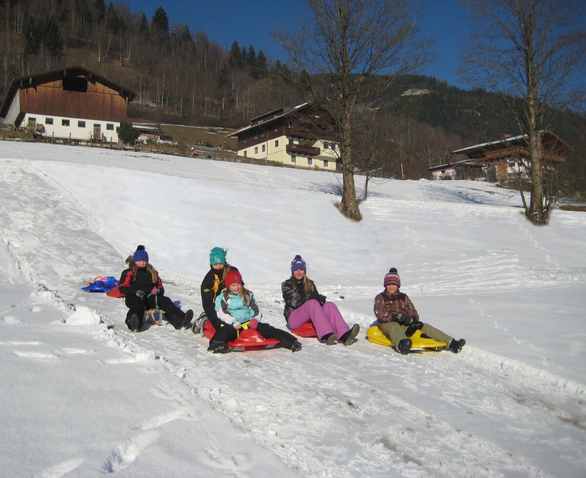 Sledding opportunities for guests on the snow-covered grounds of the Farm House.
