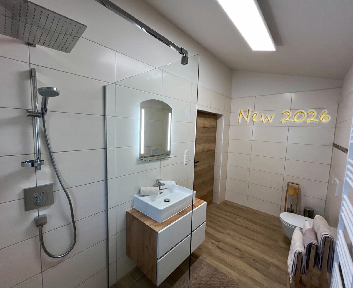 New bathroom with barrier-free shower and underfloor heating