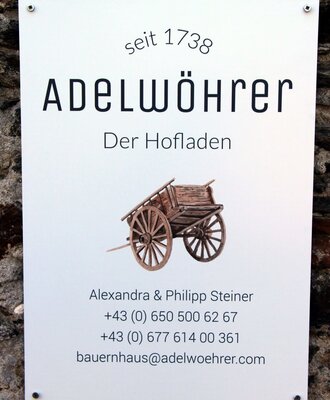 The Adelwöhrer Farm House sign, established in 1738, provides details for the property and its on-site farm shop.