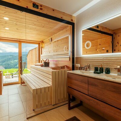 Sauna with mountain view and bathroom with double vanity