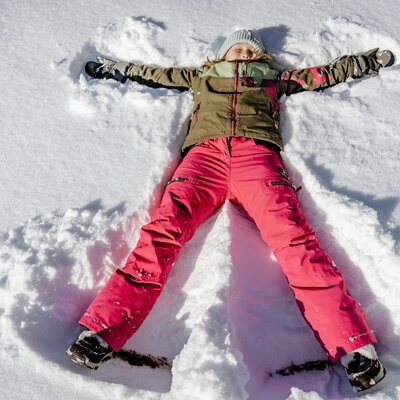 Cheerful winter fun for children in the deep snow surrounding the farmhouse.