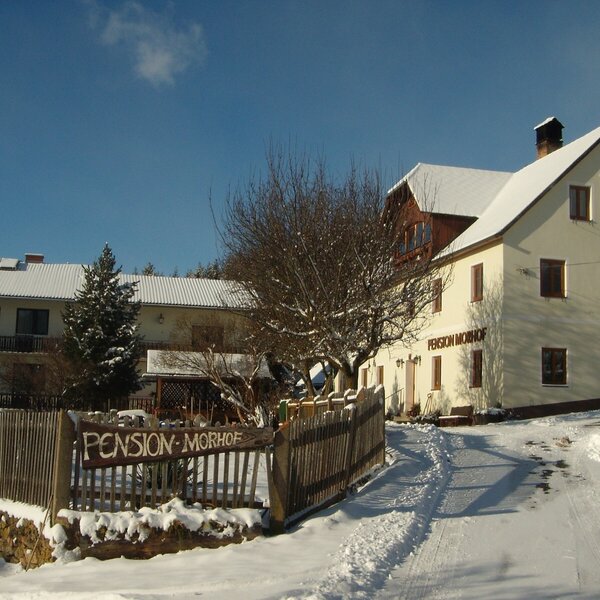 The Farm House exterior during winter, with snow-covered grounds and balconies visible on one wing. The Farm House exterior during winter, with snow-covered grounds and balconies visible on one wing.