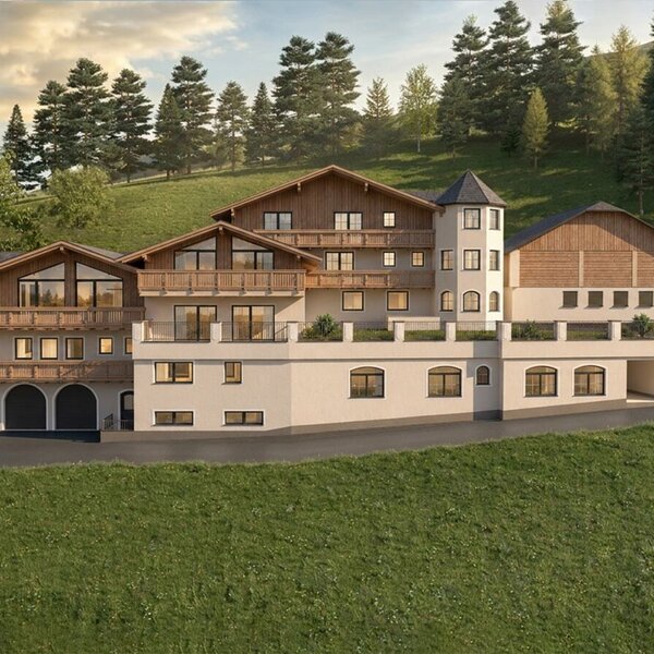 The inviting farmhouse is nestled against a lush green hillside with dense pine forests.