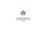 The Schirnhofer Weinbau logo, featuring a grape leaf and wine glass, signifies the farmhouse's wine-growing tradition.