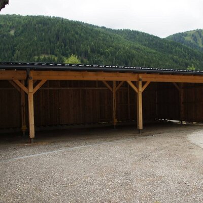The farmhouse carport with multiple parking spaces and a view of the mountains.