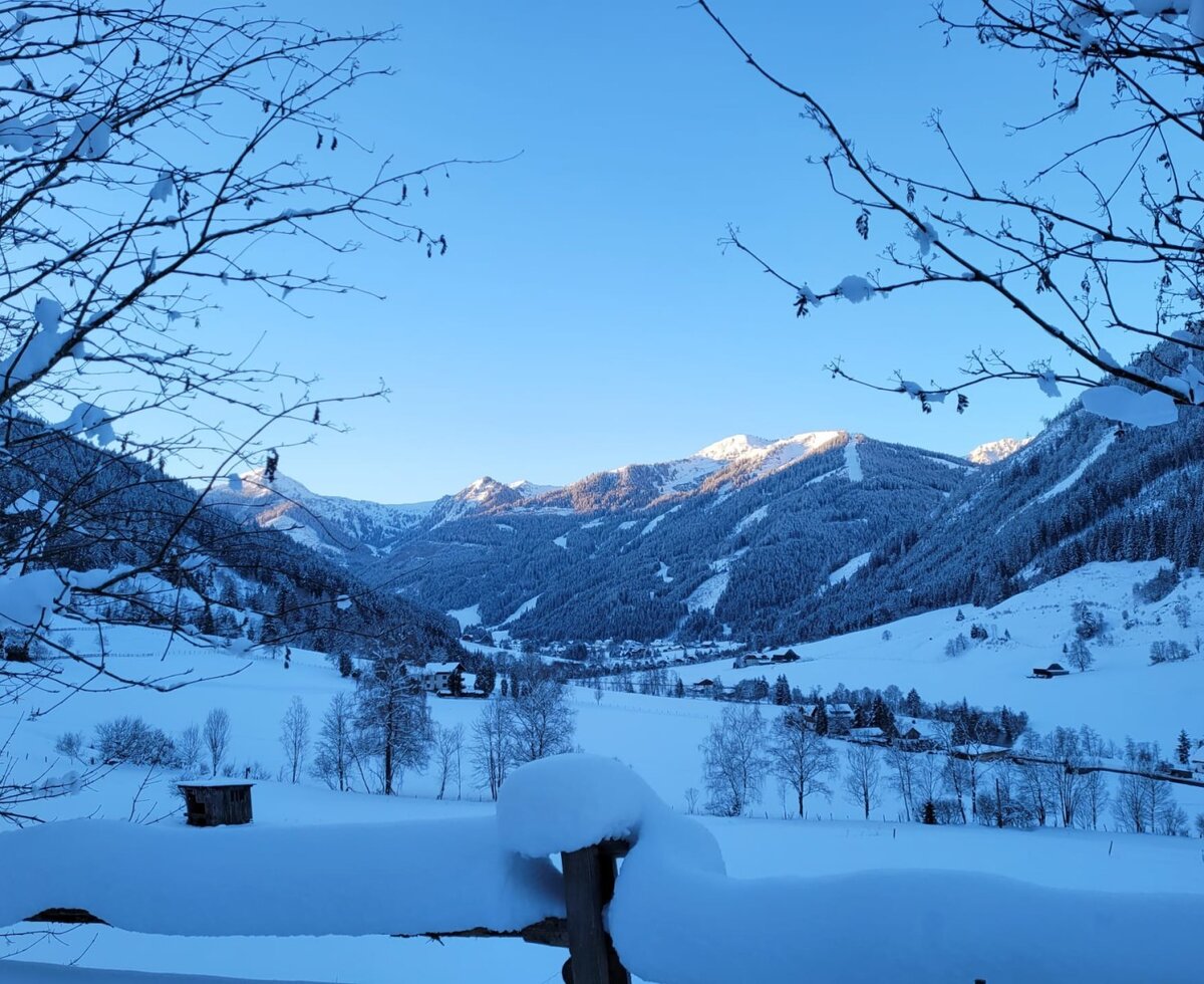 View of the snow-covered mountain landscape and valley from the farmhouse.