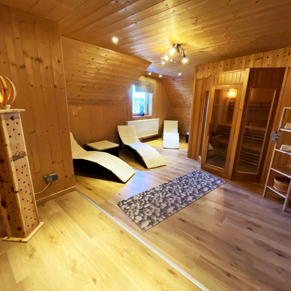 Sauna and relaxation area with a wooden sauna.