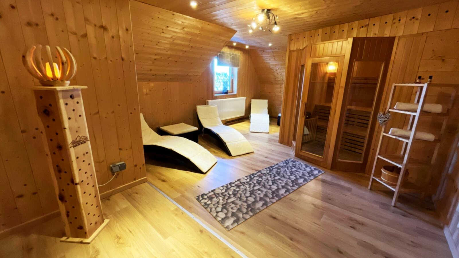 Sauna and relaxation area with a wooden sauna.