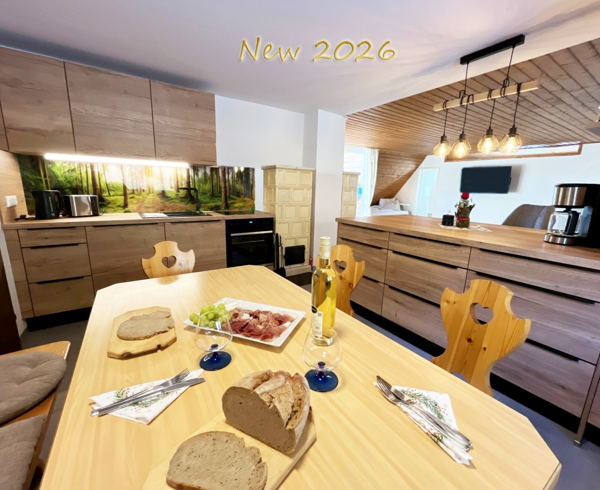 The fully equipped kitchen with the adjacent tiled stove