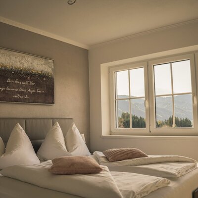 Bedroom with double bed and window with mountain view.