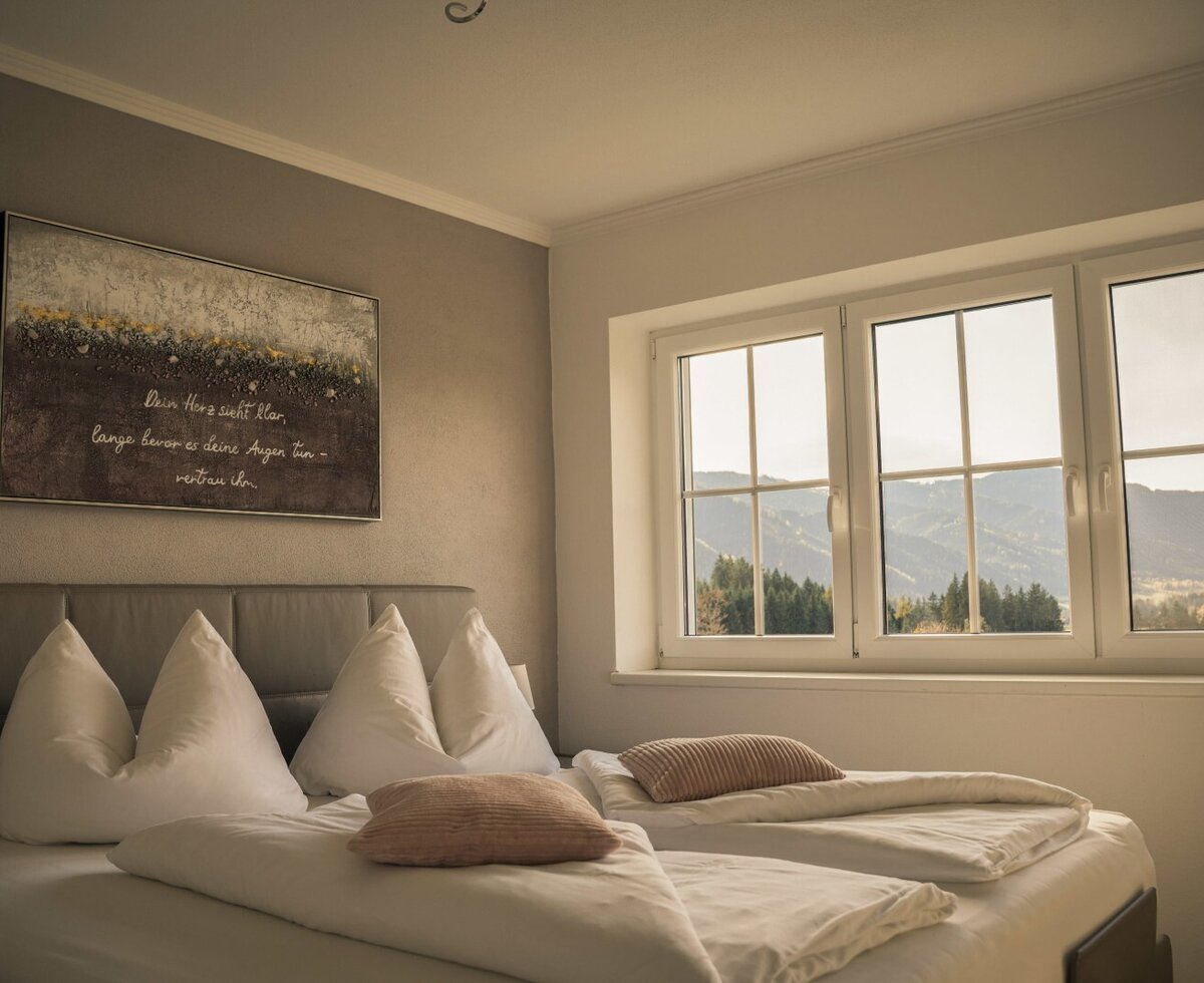 Bedroom with double bed and window with mountain view.