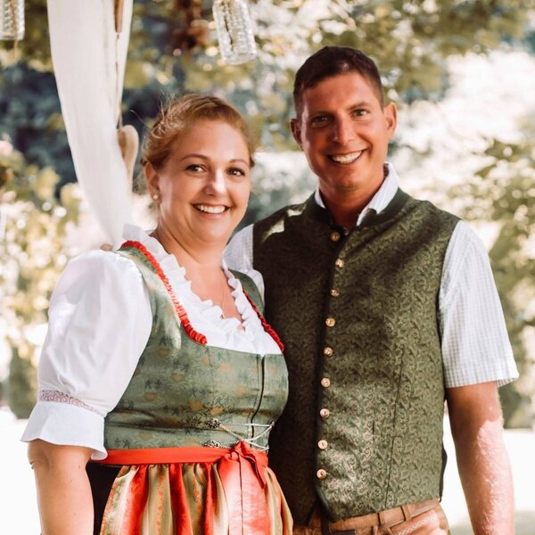 The hosts of the Farm House, dressed in traditional attire, are ready to welcome guests.