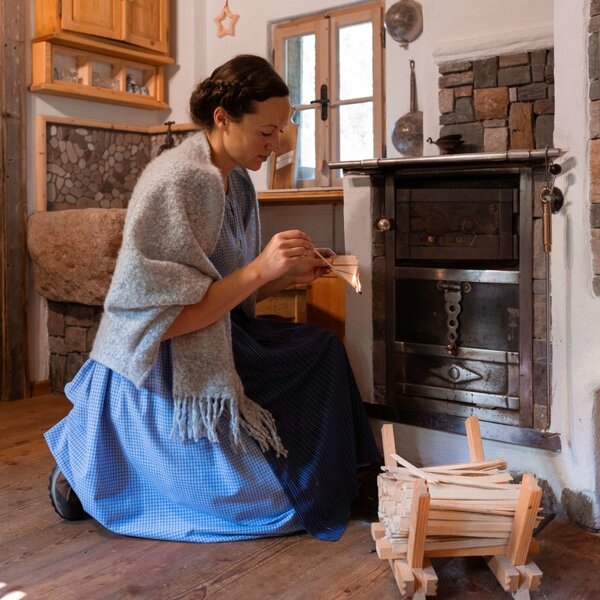 The Farm House features a rustic wood-burning stove set in stone masonry, with kindling and firewood nearby. The Farm House features a rustic wood-burning stove set in stone masonry, with kindling and firewood nearby.
