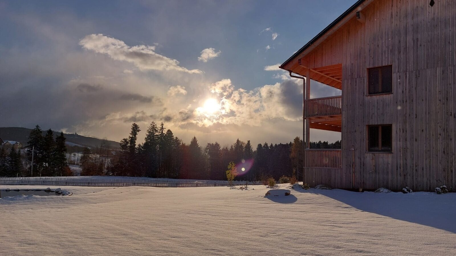 The Farm House annexe, featuring private balconies overlooking the snowy pond and rolling countryside.