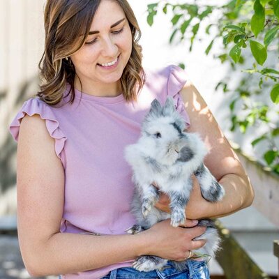 A guest holding a rabbit, one of the animals at the farmhouse.