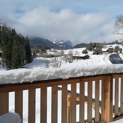 View of the snow-covered mountains and village from the Farm House's balcony.